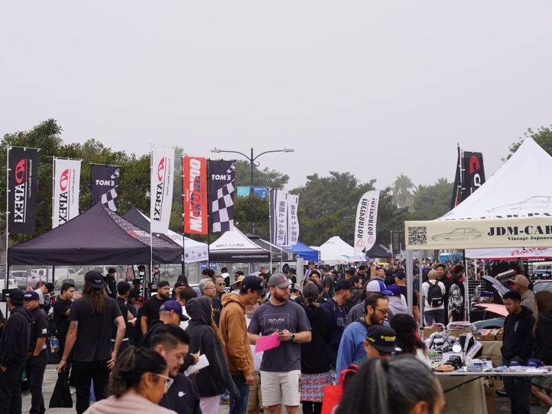 Crowd of attendees browsing displays at the Japanese Classic Car Show