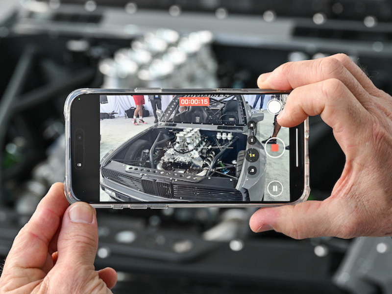 Person using mobile phone to take picture of an engine bay